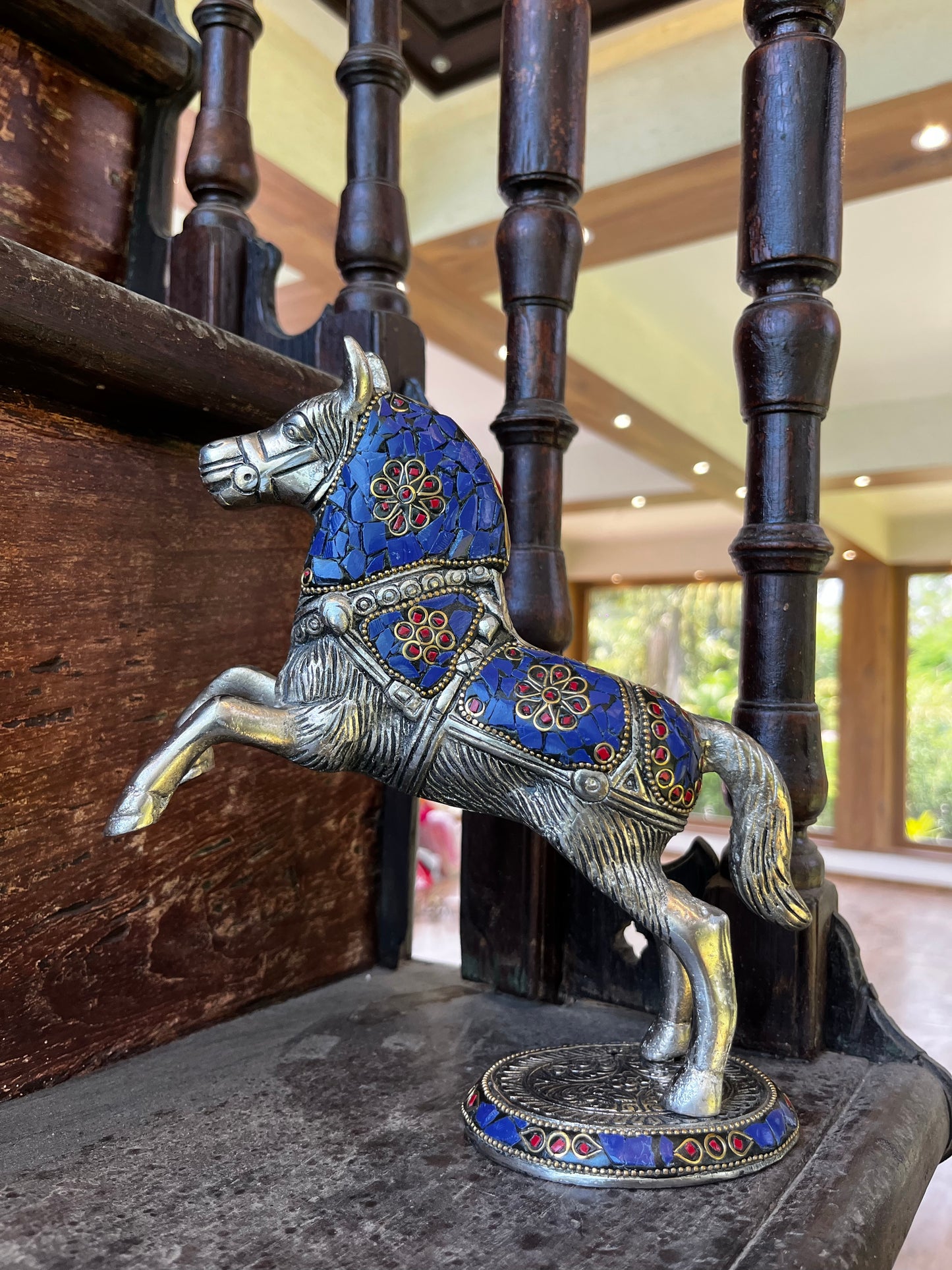 Metal jumping horse with stone