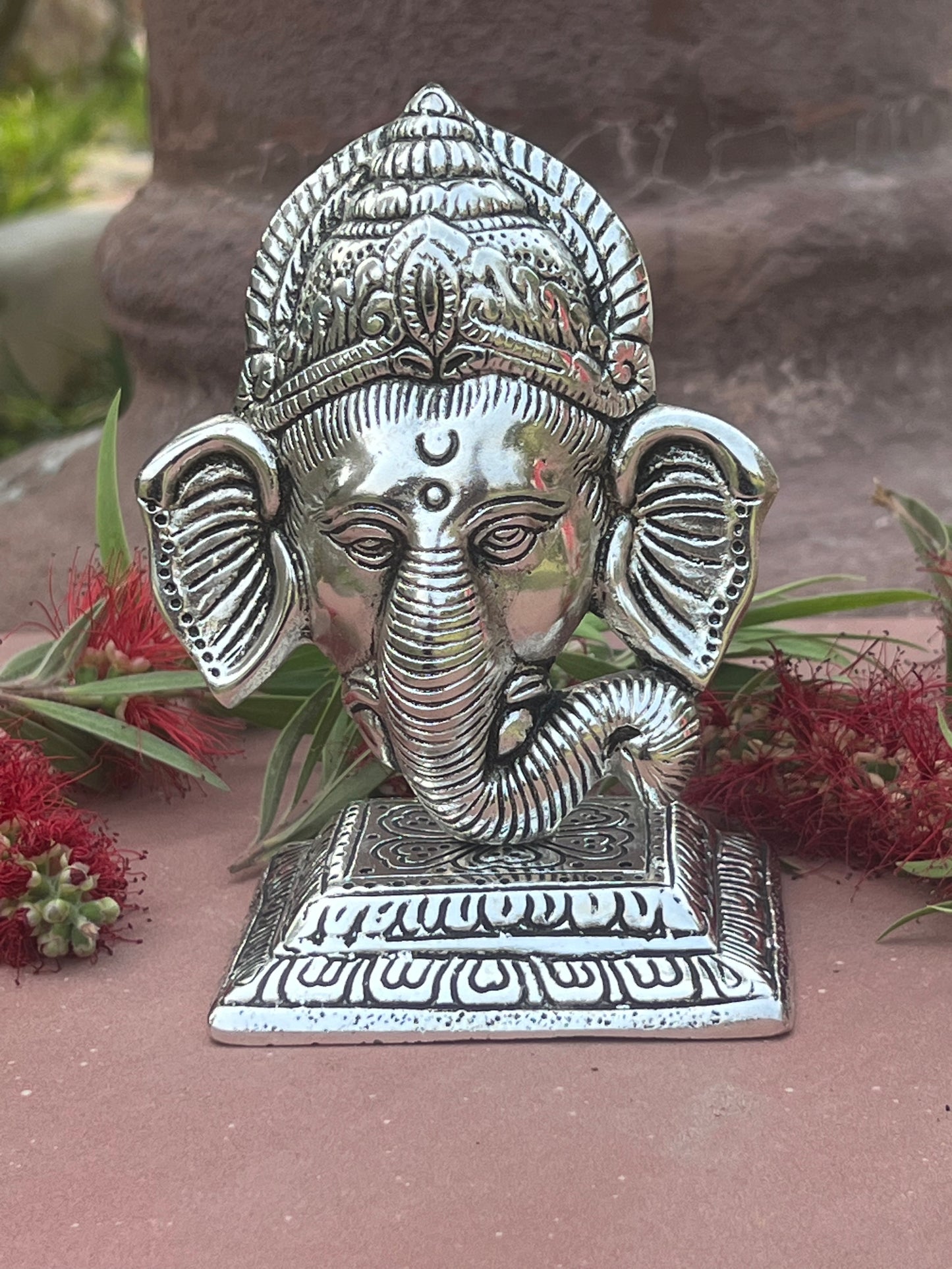 Image of Metal Stand With Ganesha Face  The Source India is an Indian Handicraft, Home Decor, Furnishing and Textiles Store. Based out of Hauz Khas Village New Delhi, each piece is carefully procured to allow the enhancement of India's Culture.