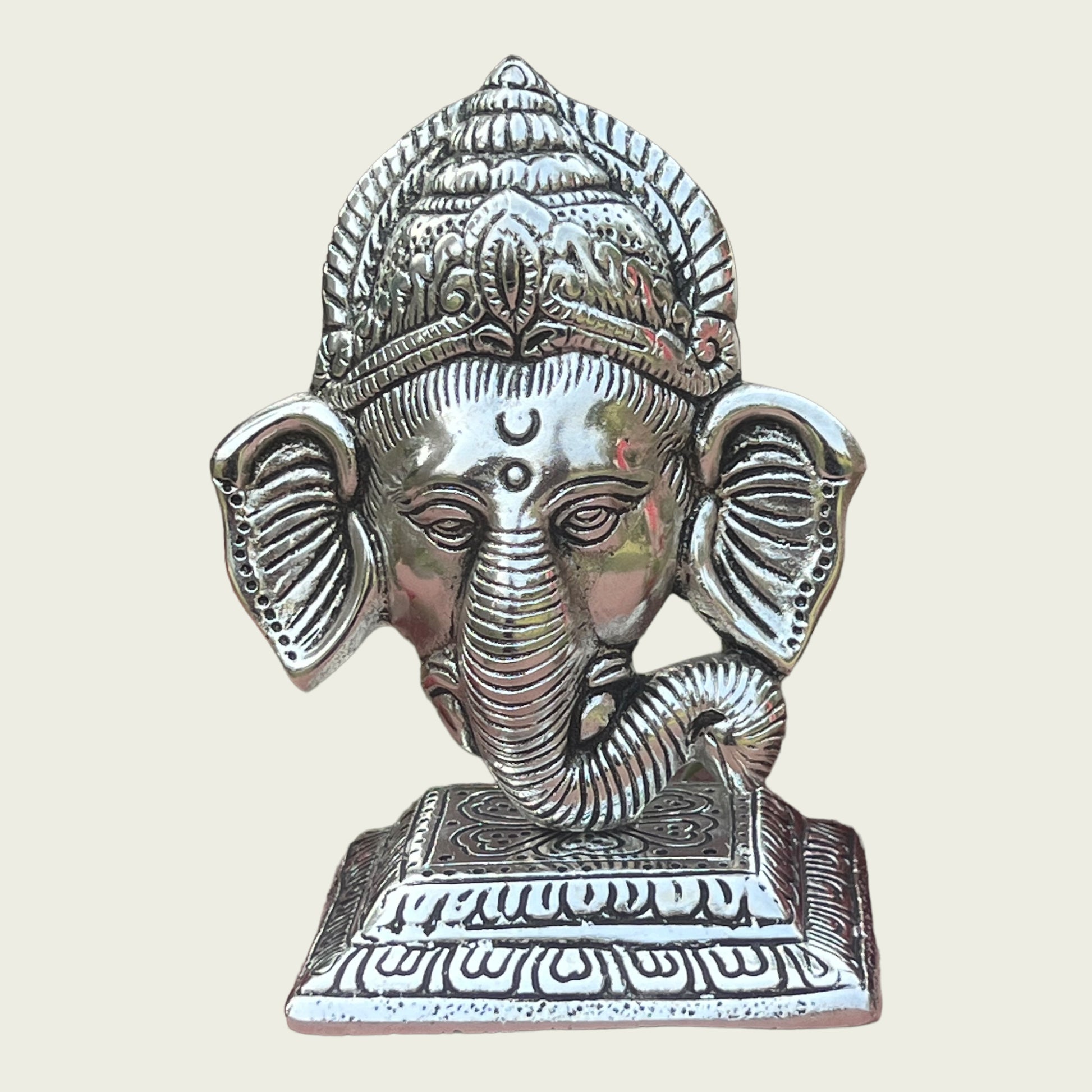 Image of Metal Stand With Ganesha Face  The Source India is an Indian Handicraft, Home Decor, Furnishing and Textiles Store. Based out of Hauz Khas Village New Delhi, each piece is carefully procured to allow the enhancement of India's Culture.