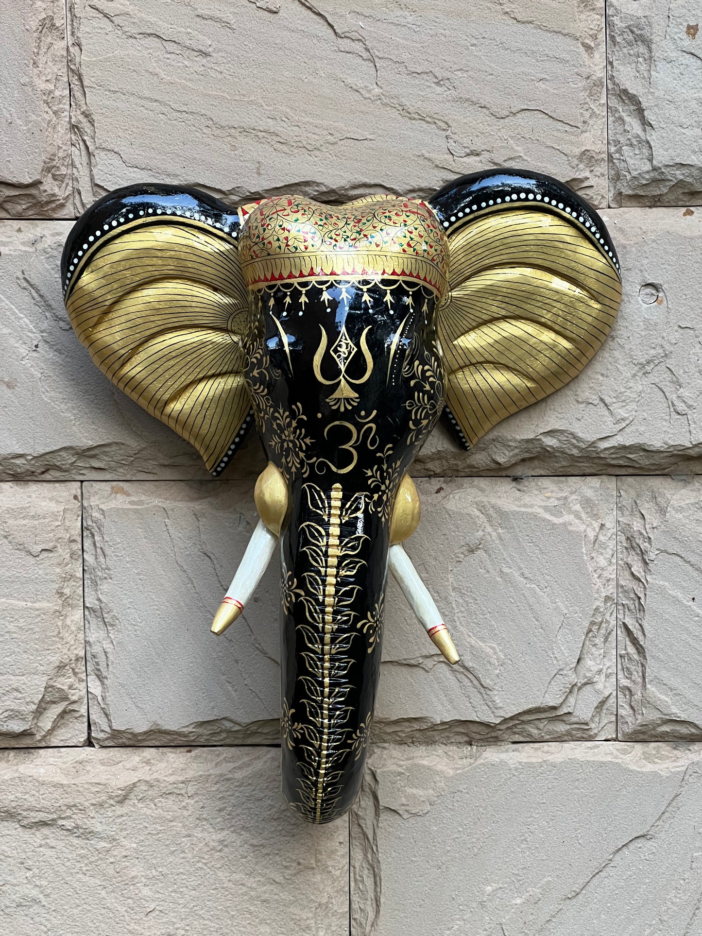 Image of Wooden Hand Painted Black Ganesha Face  The Source India is an Indian Handicraft, Home Decor, Furnishing and Textiles Store. Based out of Hauz Khas Village New Delhi, each piece is carefully procured to allow the enhancement of India's Culture.